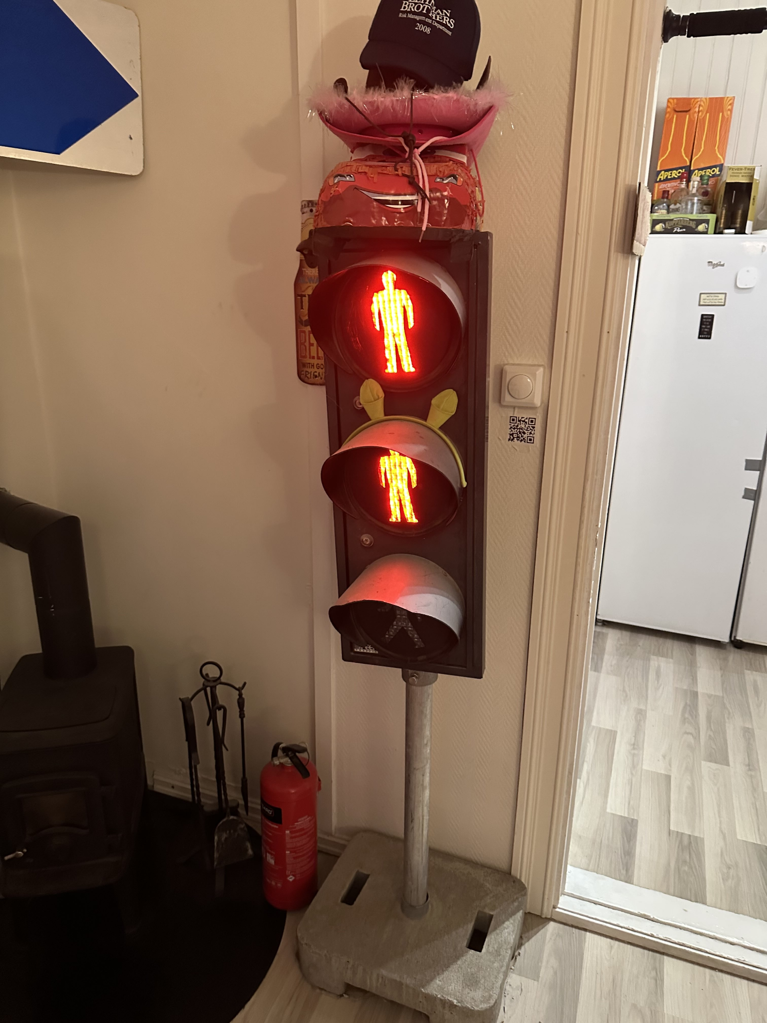 The physical traffic light with two red lamps lit and the green lamp dark. A state that exists only because we can now do whatever we want with the three lamps.